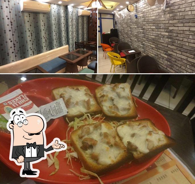 Check out the picture displaying interior and food at Cafe Paradise