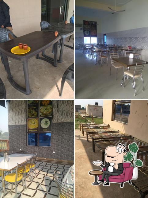 Take a seat at one of the tables at SHIVA TOURIST DHABA