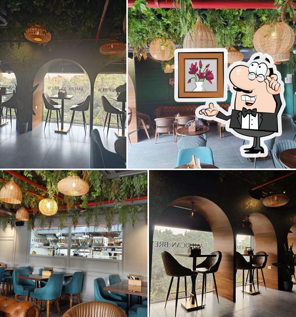 Take a seat at one of the tables at American Brew - All day American Breakfast & Cafe