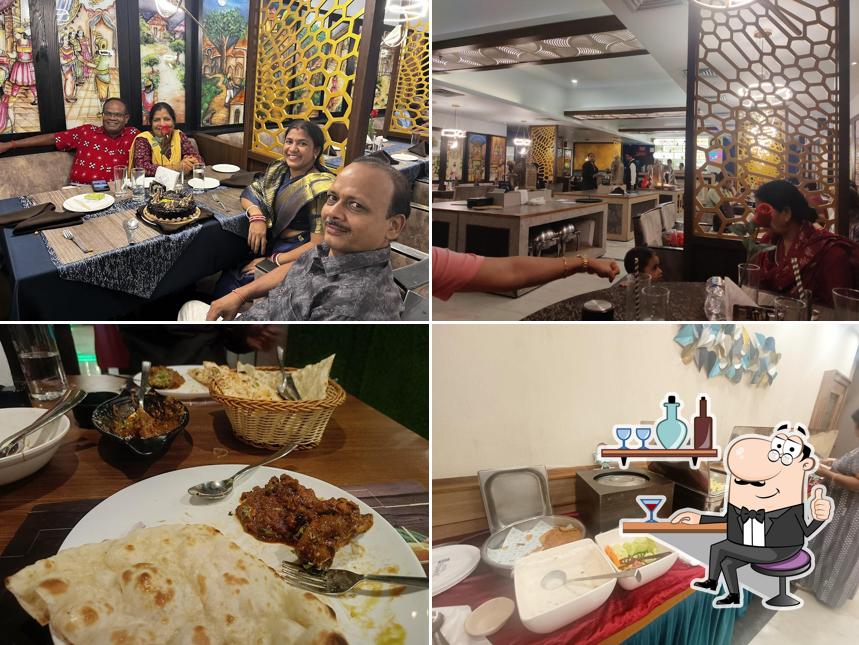 Take a seat at one of the tables at Golden Bird - Hotel Pushpak