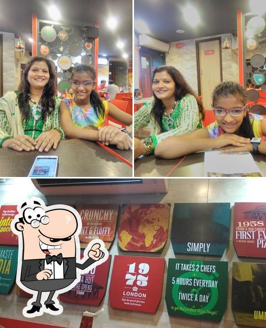 Take a seat at one of the tables at Pizza Hut Sikandra, Agra