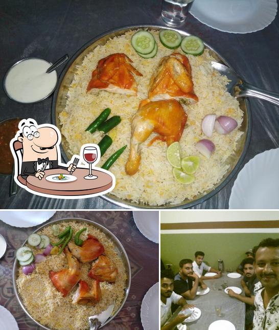 Among different things one can find food and dining table at Raydan Restaurant Nilambur