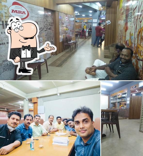 Take a seat at one of the tables at MALABAR BHAVAN RESTAURANT & MAJEEDIYA JUICE HOUSE