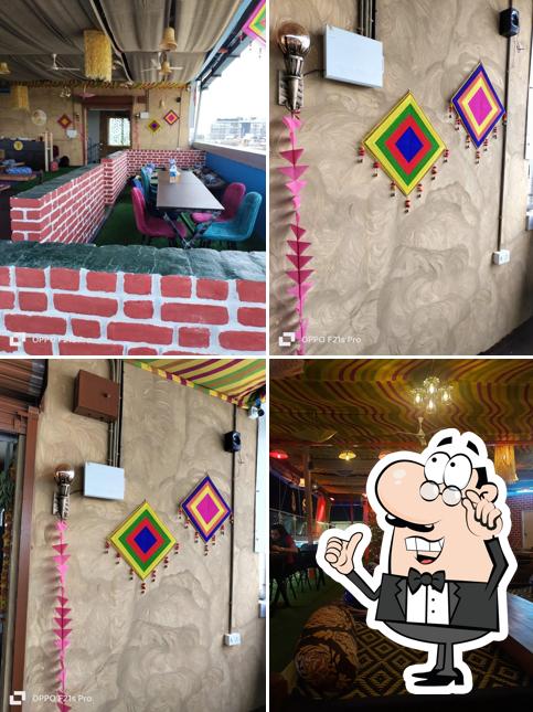 Take a seat at one of the tables at Sadda Punjabi Dhaba - Veg