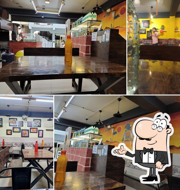 Take a seat at one of the tables at Kottaram restaurant Bangalore