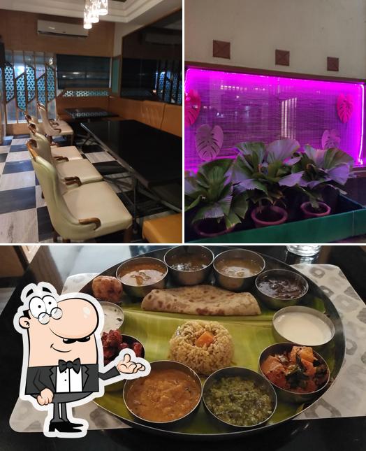 This is the image depicting interior and food at Hotel Aryaas Restaurant