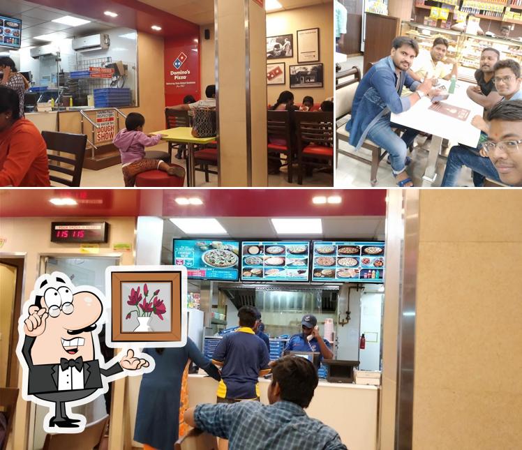 Take a seat at one of the tables at Domino's Pizza Ranganatha Nagar, Chennai