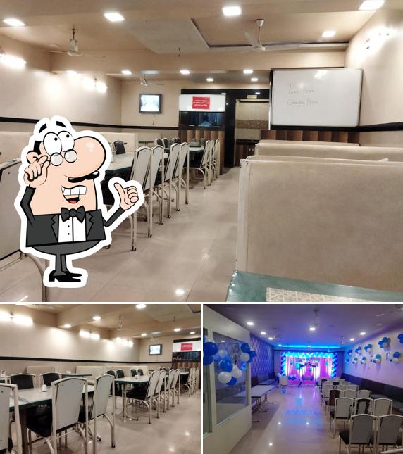 Take a seat at one of the tables at HOTEL SARANG PURE VEG