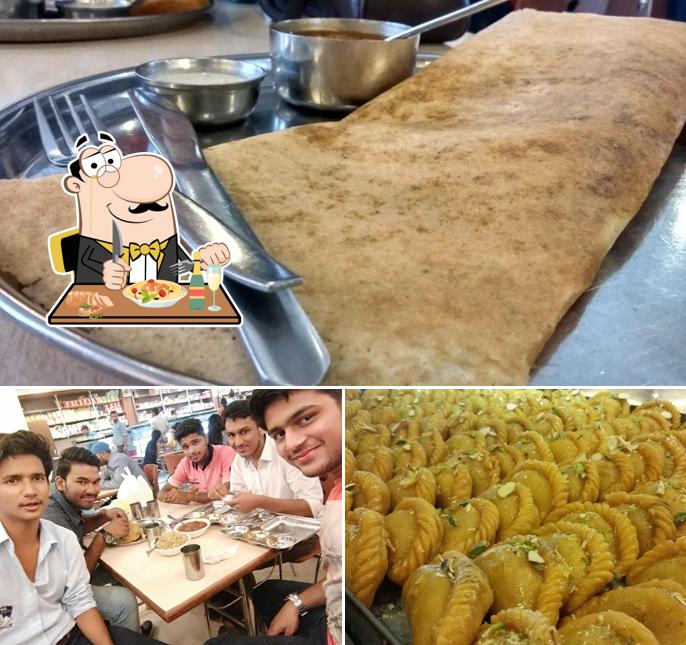 Among various things one can find food and dining table at Navrang Sweets & Fast Food