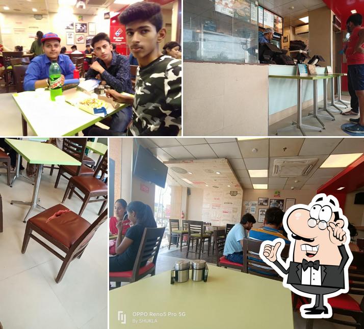 Take a seat at one of the tables at Domino's Pizza Urahat, Rewa