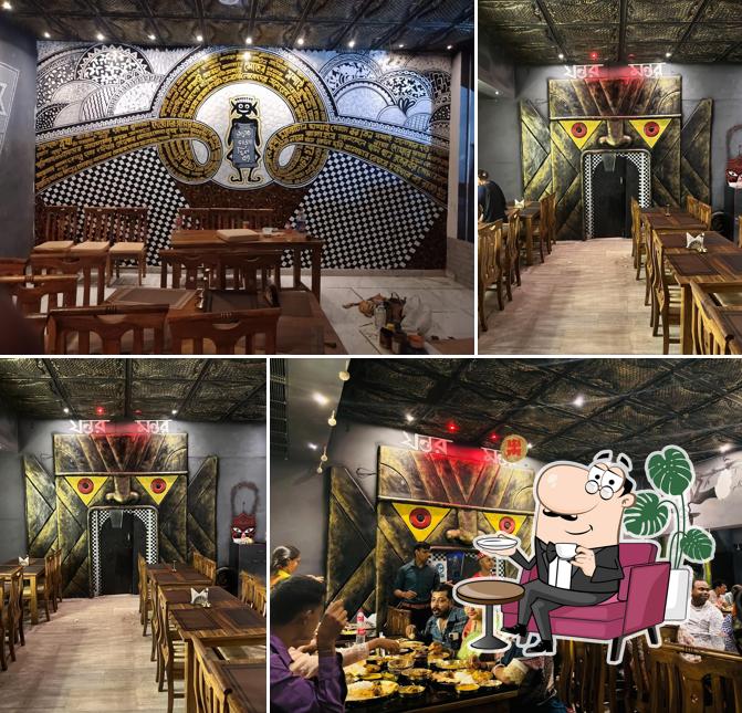 Take a seat at one of the tables at Bhooter Raja Dilo Bor - Durgapur