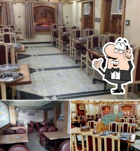 Take a seat at one of the tables at Karnavati Dining Hall