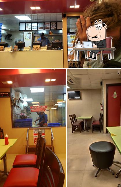 Take a seat at one of the tables at Domino's Pizza Siolim, Goa