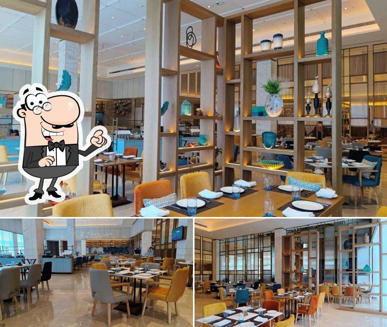 Take a seat at one of the tables at Viva - All Day Dining Holiday Inn