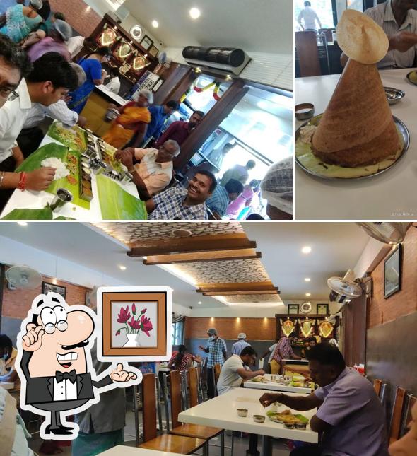 Take a seat at one of the tables at Hotel Sree Sabarees - Arasaradi