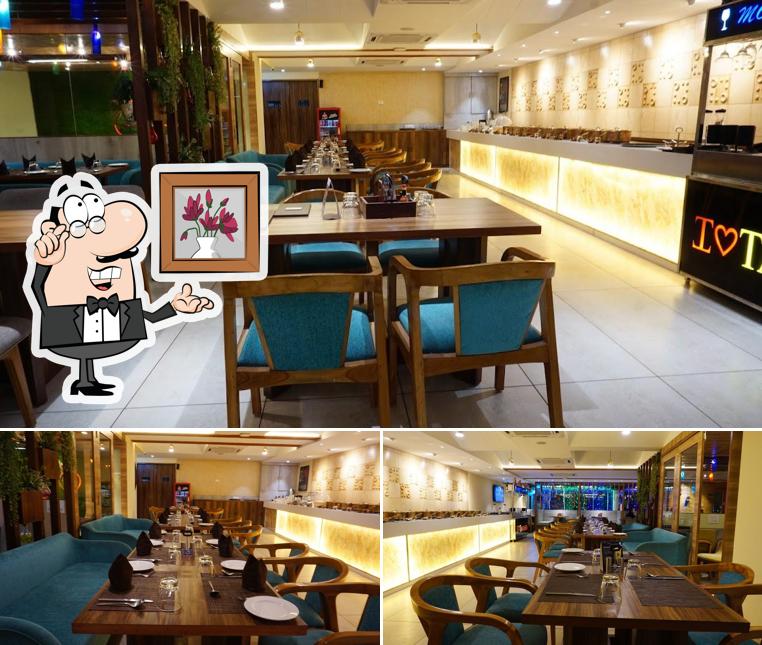 Take a seat at one of the tables at Indian Tamasha Cafe and Restro