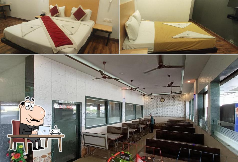 Take a seat at one of the tables at HOTEL PARIVAR GARDEN All VEG AND DELUXE ROOMS