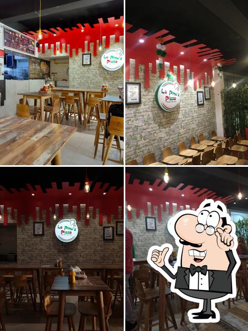 Take a seat at one of the tables at La Pino'z Pizza - 150 ft Ring Road Circle