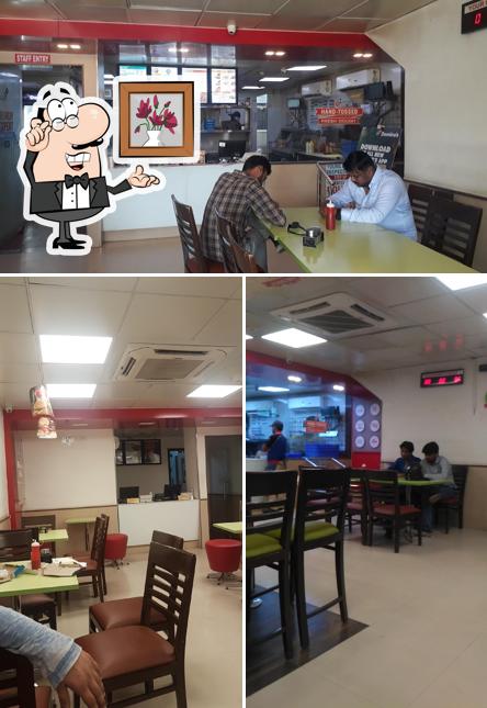 Take a seat at one of the tables at Domino's Pizza MP Nagar, Satna