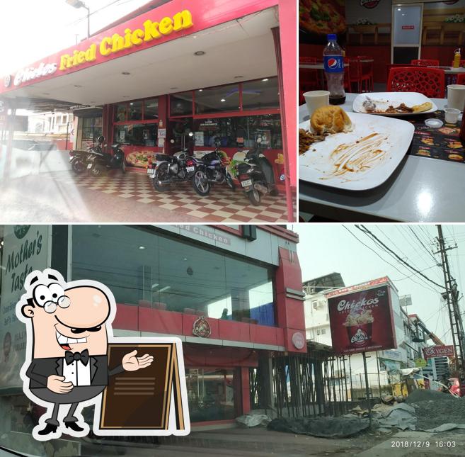 This is the picture showing exterior and dining table at Chickos Fried Chicken Thiruvalla