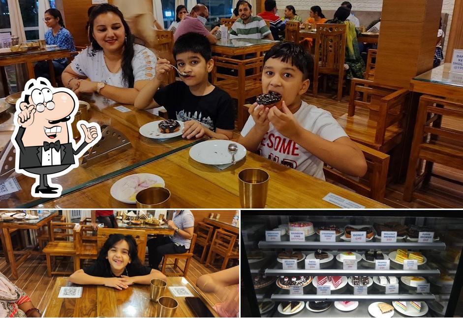 Take a seat at one of the tables at Yatharth Bhoj Pure Veg Smart Restaurant