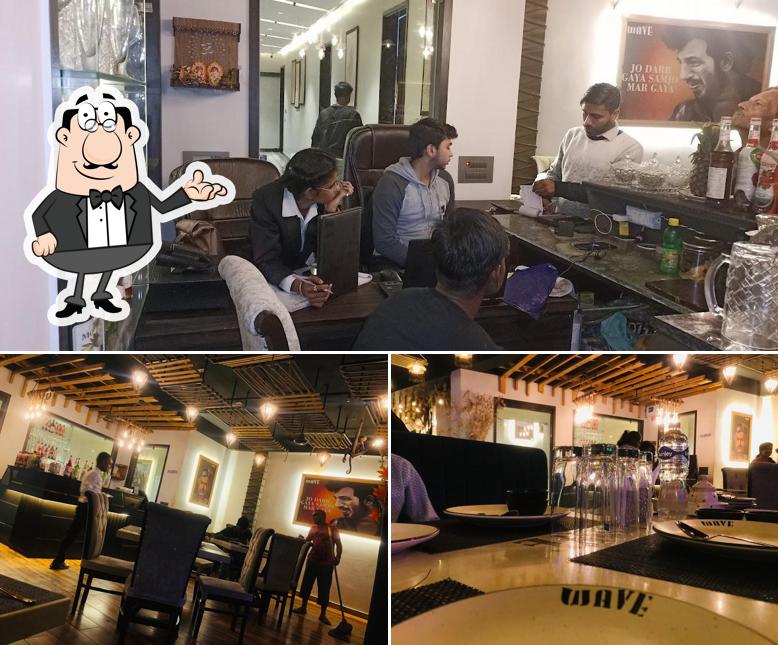 Take a seat at one of the tables at WAVE- The Food Plaza HOTEL & Restaurant