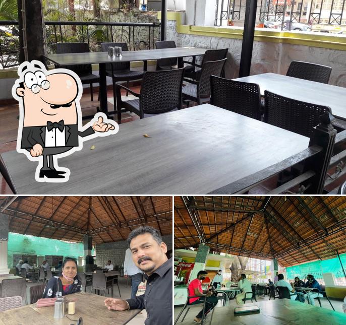 Take a seat at one of the tables at Hotel Real Hanuman Resto Veg