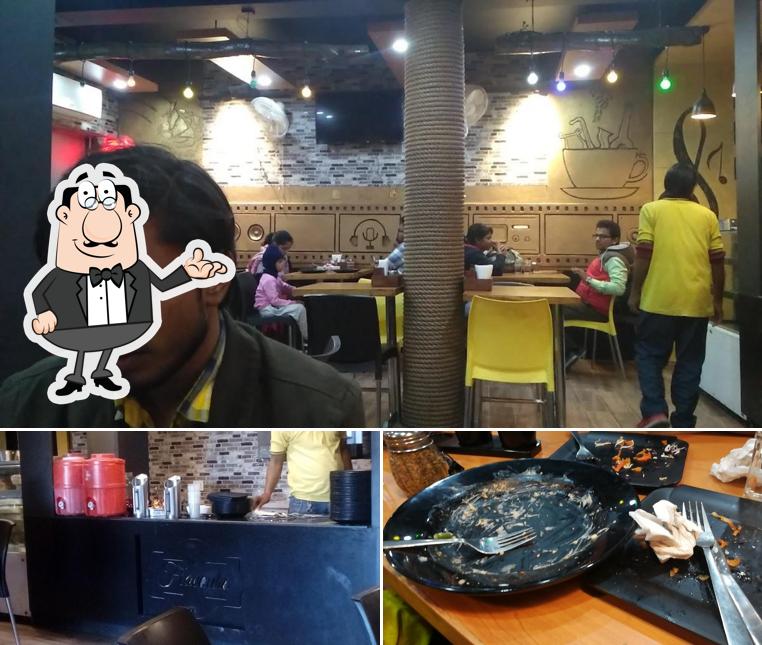 Take a look at the image depicting interior and food at The Flavours