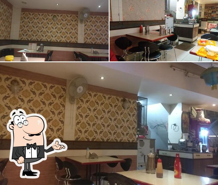 Take a seat at one of the tables at Bholla Sweets & Bakery