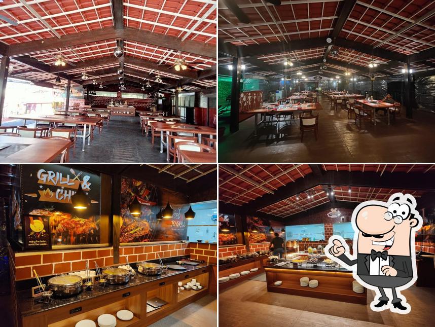 Take a seat at one of the tables at Barbeque Bay Mahabaleshwar by Club Mahindra