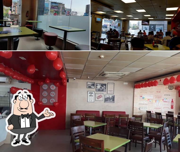 Take a seat at one of the tables at Domino's Pizza City Centre, Hoshiarpur