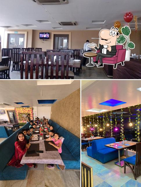 Take a seat at one of the tables at Jharokha Restaurant