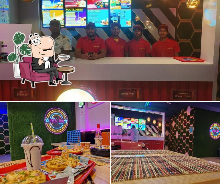 Take a seat at one of the tables at GRILL INN BERHAMPUR