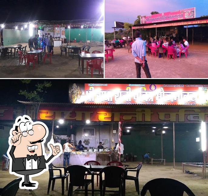 Take a seat at one of the tables at Shree Radha Rani Restaurant