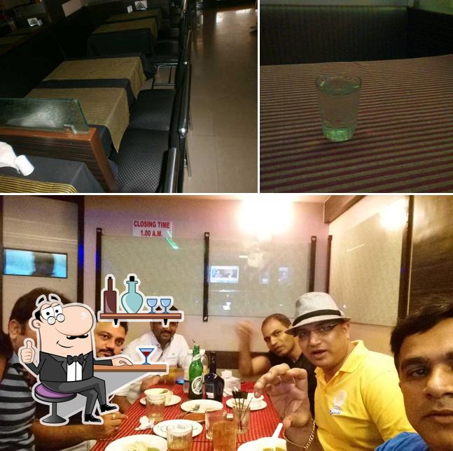Take a seat at one of the tables at Pooja Restaurant And Bar