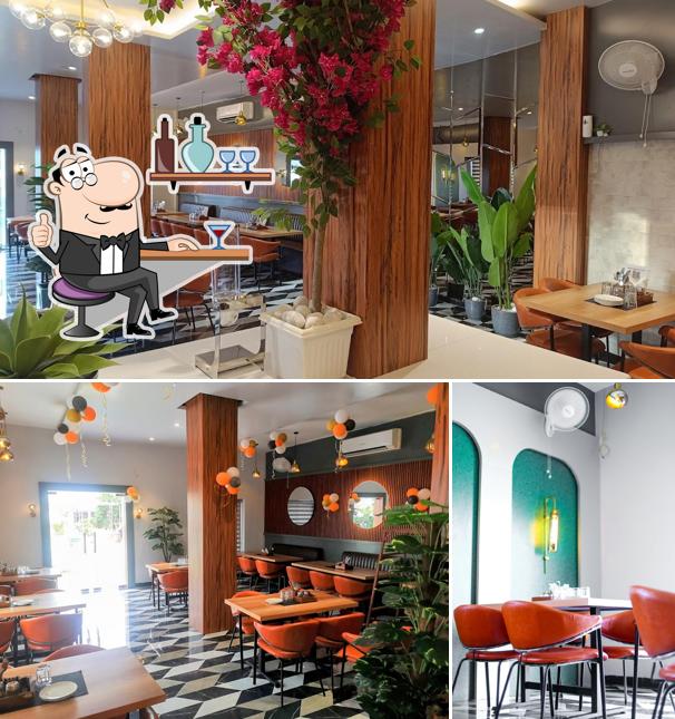 Take a seat at one of the tables at SAFFRON RESTAURANT BY OASIS