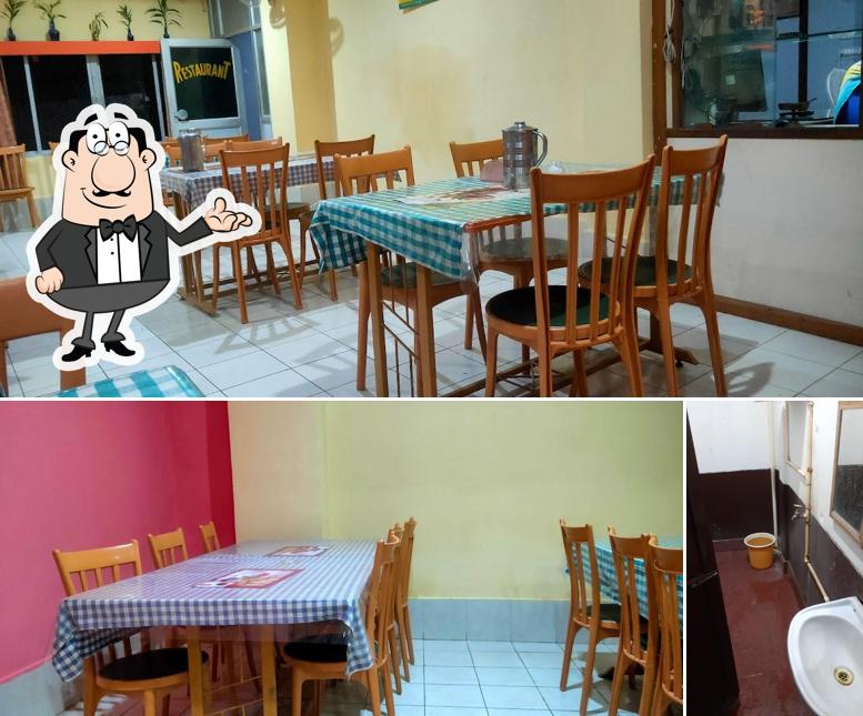 Take a seat at one of the tables at HOTEL SWAGATHAM