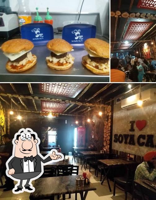 Take a look at the photo showing interior and burger at Soya cafe the family point