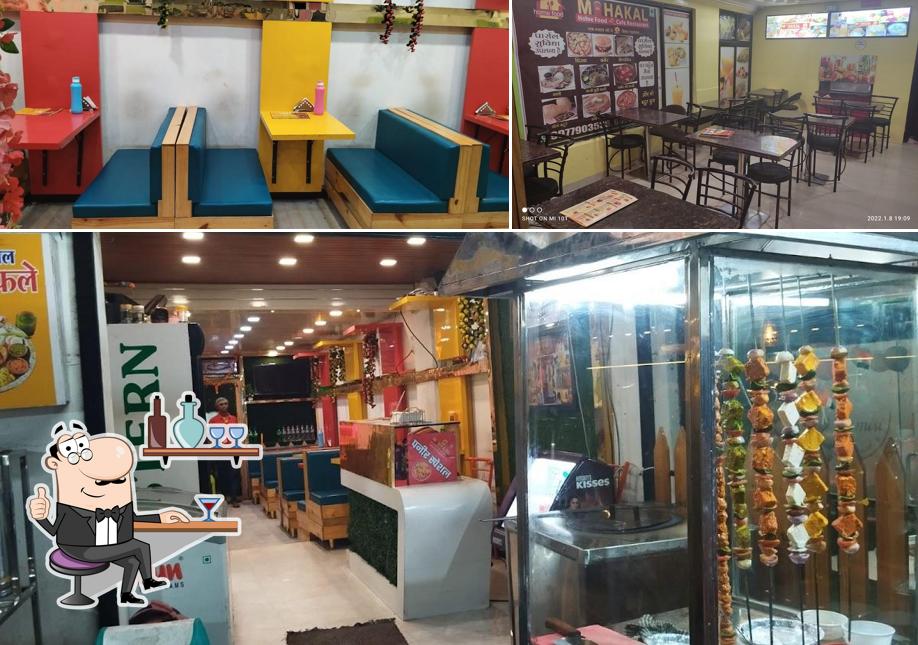 Take a seat at one of the tables at Mahakal Home Food And Restaurent Nanakheda