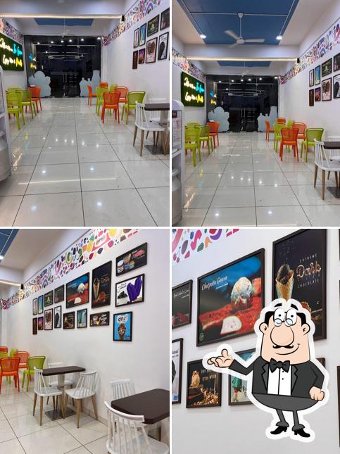 Take a seat at one of the tables at DNS Desserts N Shakes Bhuj