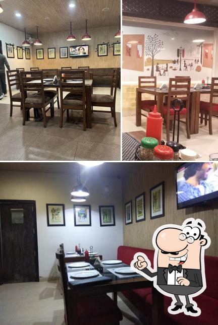 Take a seat at one of the tables at Pizza Asia