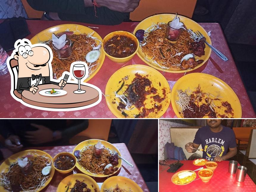 Check out the photo displaying food and dining table at Suraj Chinese