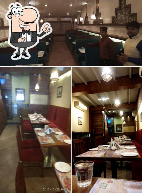 Take a seat at one of the tables at Shalimar Restaurant