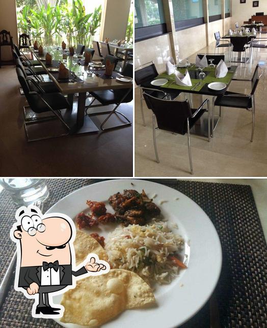 Among various things one can find interior and food at Blue Bell Multi Cuisine Restaurant - Flora Airport Hotel