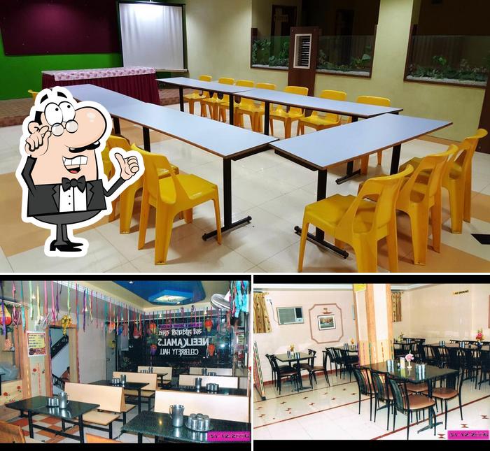 Take a seat at one of the tables at HOTEL NEELKAMAL PURE VEG