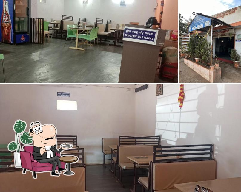 Take a seat at one of the tables at Happy Lunch Hotel -Veg & NonVeg