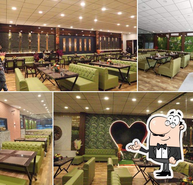 Take a seat at one of the tables at Khatirdari Veg & Non-Veg Restaurant