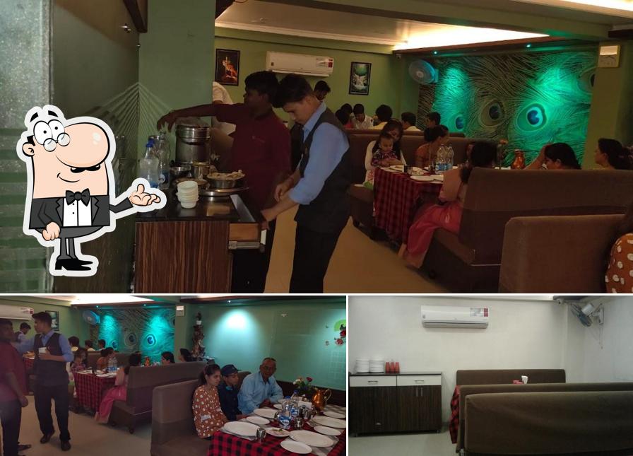 Take a seat at one of the tables at Mejwani Dining Pure Veg Restaurant