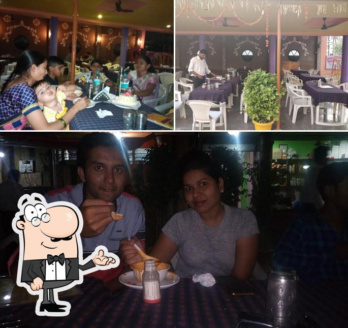 Take a seat at one of the tables at Sanskruti Garden Restaurant Akola