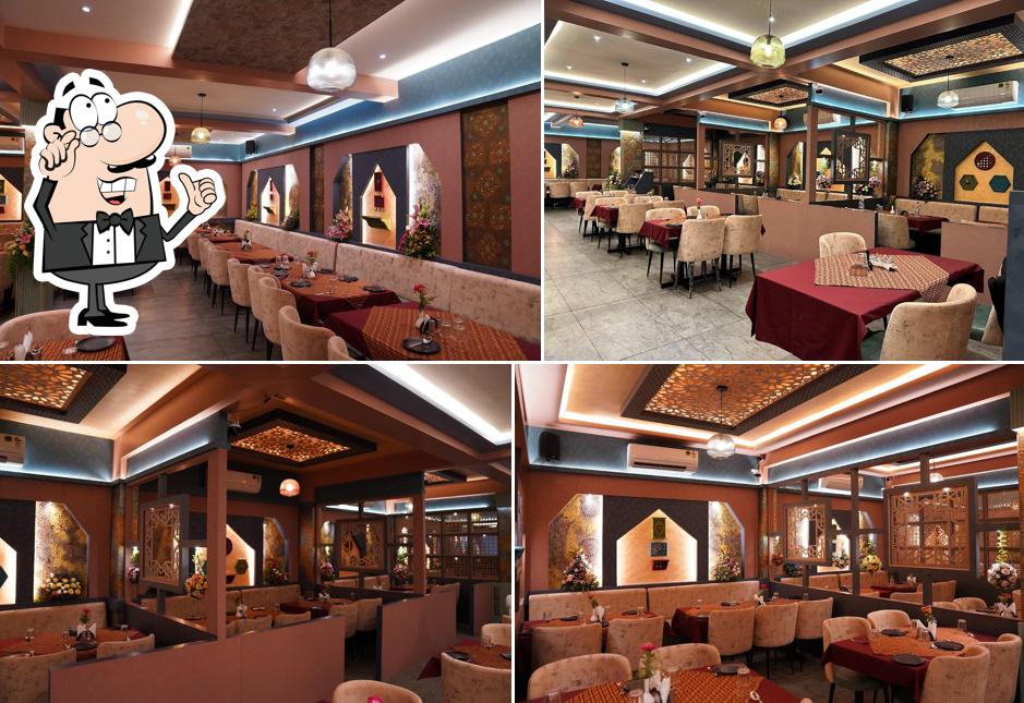 Take a seat at one of the tables at Aroma's Hyderabad House
